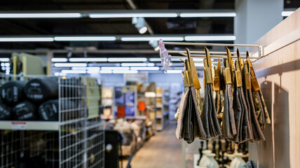 Hanging textiles with patterns displayed for sale in a retail store aisle