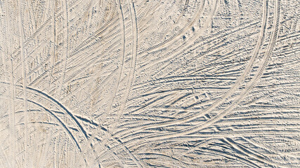 Aerial view tire tracks on sandy beach, Tire tracks on the sand  surface texture background, Tire...