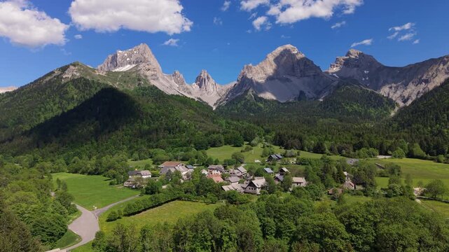 Aerial view of La Jarjatte village in the Vercors Natural Park. Limestone mountain peaks of Devoluy Massif, Drome, French Alps, France