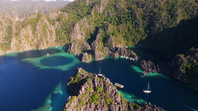 Drone vista over the emerald waters and jagged rock formations of Twin Lagoon, a world-famous travel destination