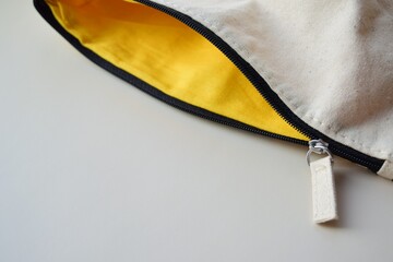 An open zipper on a fabric bag © LineDP