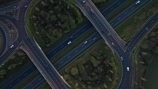 Aerial drone perspective of a busy yet smooth-flowing highway interchange on Ireland&rsquo;s N4 during sunset. Cars move gracefully along curved roads framed by rich green fields. A perfect blend of nature 