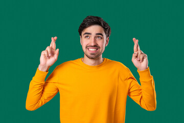 Fototapeta premium Handsome Man Crossing Fingers. Praying With Hopeful Expression, Silently Prays