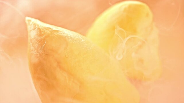 Macro Close-up of Fresh Golden Durian Flesh with Swirling White Mist Smoke on Warm Background, Tropical King of Fruits for Food Ads
