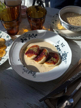 Cottage Cheese Pancakes with Jam, Ground Pistachios and Creamy Sauce. Cozy Homemade Breakfast Concept. Handmade Phone Photo, Selective Focus, Harsh Sunlight, Non AI