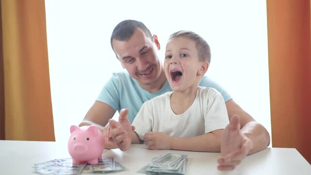 Man and little girl sitting at table with piggy bank. Family counts money in bank. Young girl counts lifestyle her sons savings. A man and a young girl are seated at a table with a piggy bank.