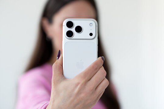 
Kyiv, Ukraine. March 20, 2026. Close up of woman holding iPhone 17 Pro, focus on triple camera system and modern smartphone design
