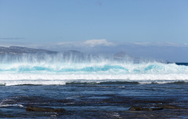 Naklejka premium Gran Canaria, view towards Atlantic ocean from El Confital beach on the edge of Las Palmas de Gran Canaria, big waves crushing