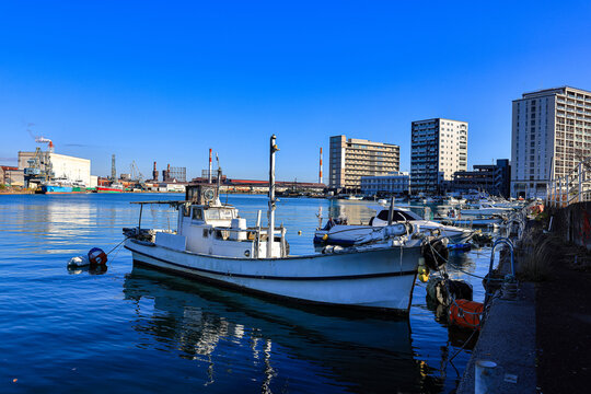 Small fishing boats are docked in a coastal town near  Kitakyushu, Japan.