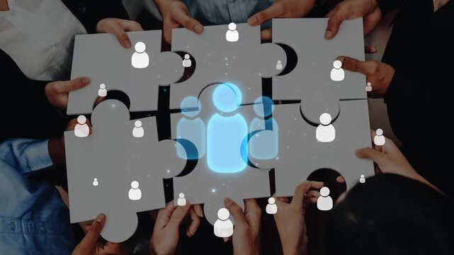 Hands gather puzzle pieces to create a glowing silhouette, symbolizing teamwork and collaboration. This image represents unity and creative problem solving in any environment. Raster