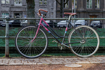 Vintage Bicycle Parked by Canal in City Street © Maksym Hilievoi