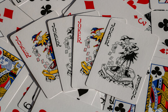 Joker playing cards spread on a surface - close-up of classic deck details