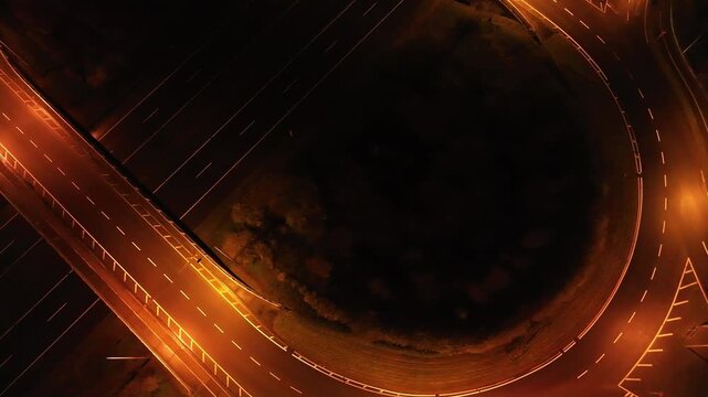Drone shot of illuminated motorway junction on N4 Ireland at night with smooth flowing traffic.