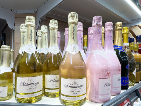 Villach, Austria - March 19, 2026: Schlumberger sparkling wine bottles displayed on a shelf with various other sparkling beverages in a retail setting