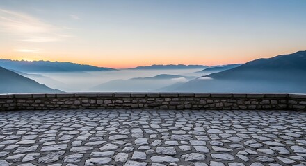 Fototapeta premium Stone terrace overlooking misty mountain valley at sunrise