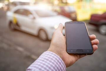 the hand with the phone in hand on the background of taxi car © Polivan