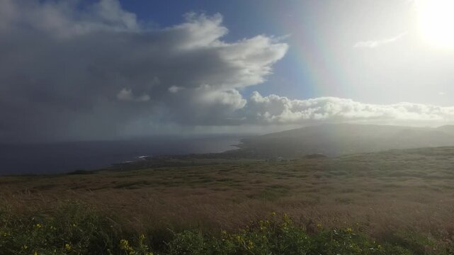 Bright Coastal Scene With Clouds. Tranquil Oceanfront Vista With Vibrant Rainbow And Billowing Clouds in Papa Nui Easter Island