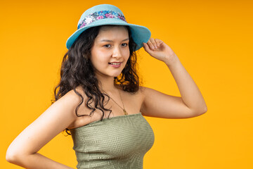 Fototapeta premium Young woman wearing blue hat smiling outdoors