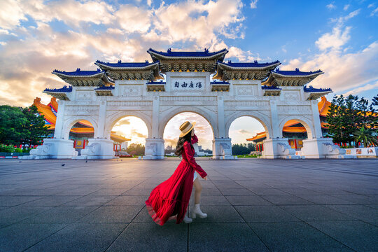 Asian woman walking in Archway of Chiang Kai Shek Memorial Hall in Taipei, Taiwan.