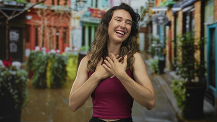Fototapeta premium Woman with arms extended in welcoming hug on vibrant cobblestone street flanked by lush potted plants; joyful welcome.