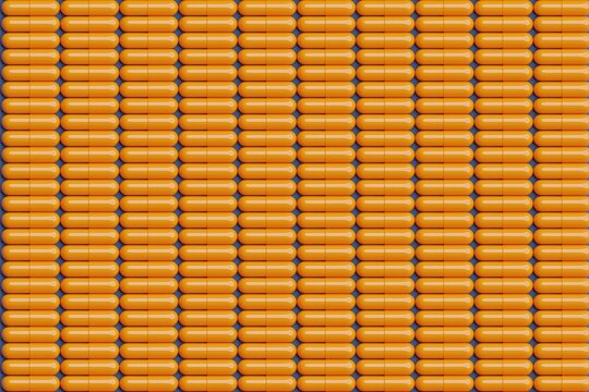 Orange pills on blue surface. Top flat view