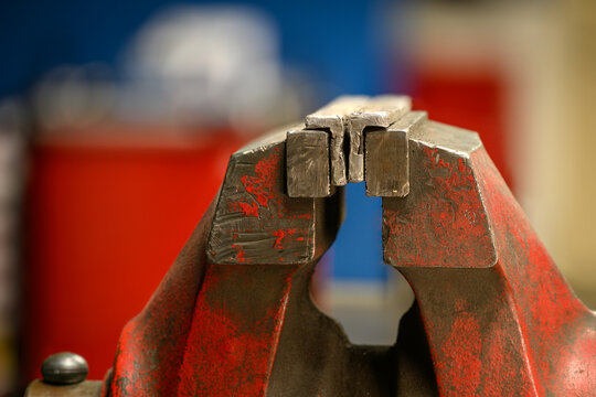 An aluminum insert in a red workshop vise.