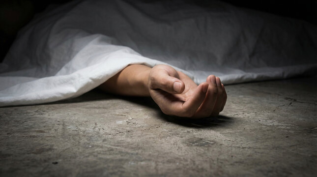 Dead body covered with a white sheet on a concrete floor with one arm sticking out, representing a crime scene or morgue