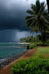 Fototapeta premium Coastal promenade with palm trees and manicured lawn beside turquoise sea under looming dark storm clouds and distant rain creating a dramatic seaside walkway scene