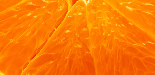 Fototapeta premium Macro Shot of Fresh Juicy Orange Pulp Texture,Extreme close-up macro shot of vibrant orange fruit pulp and segments. The image highlights the detailed texture, juice vesicles, and bright citrus colors
