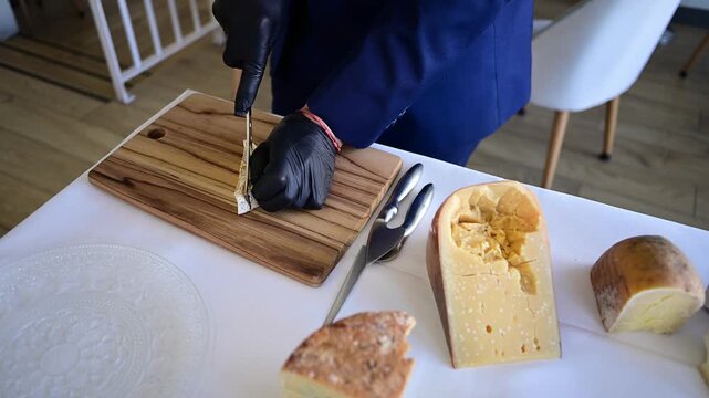 Sommelier preparing an assorted cheese platter for tasting