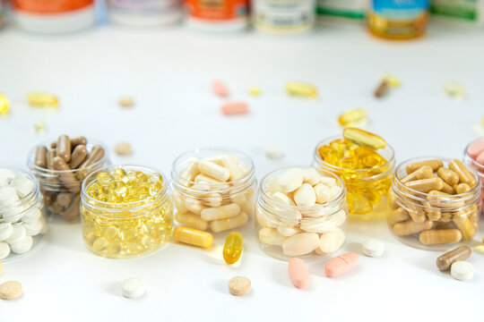 Supplements and vitamins on a white background. Selective focus.