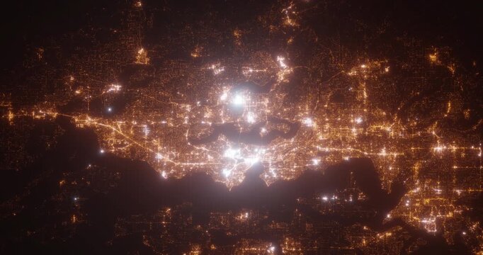 Seattle (Washington, USA) top view at night. Aerial view on modern city with lights. Camera is flying above the city, moving backward. Vertical video. The north is on the left side