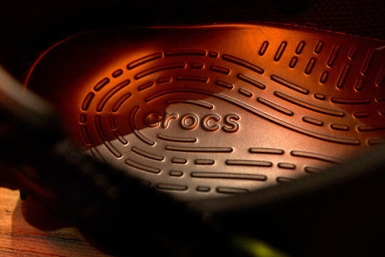 Tyumen, Russia-February 15, 2026: crocs echo clog showing the brand logo and sole design with warm lighting