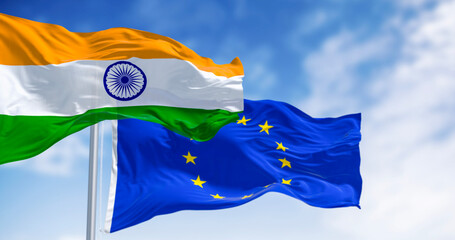 Flags of India and the European Union waving on a clear day