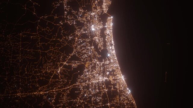 Biloxi (Mississippi, USA) top view at night. View on modern city from satellite. Camera is zooming in, rotating counterclockwise. Vertical video. The north is on the left side