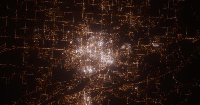 Bismarck (North Dakota, USA) aerial view at night. Top view on modern city with street lights. Camera is zooming out, rotating clockwise. Vertical video. The north is on the left side