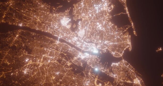 New York City (New York, USA) top view at night. Aerial view on modern city with lights. Camera is flying above the city, moving backward. Vertical video. The north is on the left side