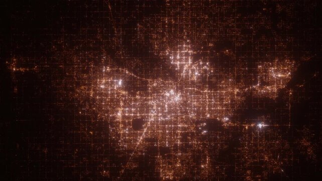 Oklahoma City (Oklahoma, USA) top view at night. Aerial view on modern city with lights. Camera is flying above the city, moving backward. Vertical video. The north is on the left side