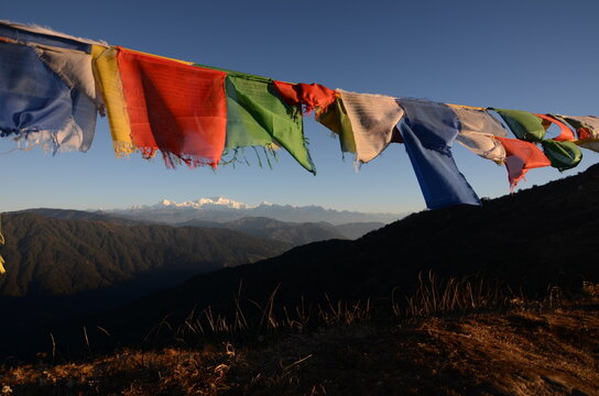 Buddhist Prayer flags fluttering in the wind with himalayas in the background