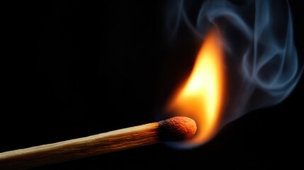 Small match flame ignites in darkness with smoke rising in deep black background