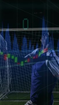 Executing bicycle kick, soccer player in blue kit at night near goal net with digital overlays