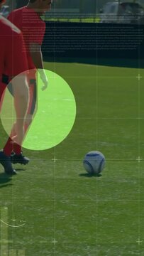 Dribbling player in red training top moving on sunlit pitch, HUD analytics showing soccer ball