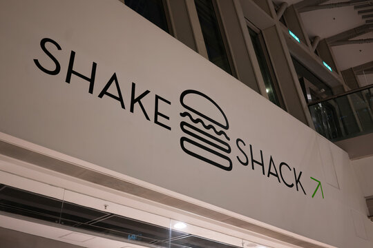 Shake Shack directional sign with logo and arrow at IFC Mall in Hong Kong