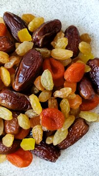 Dried apricots, raisins, and candied fruits as ingredients for baked goods and sweets. Dried fruits as a food background for your design