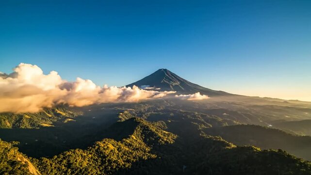 Epic sunrise over jagged mountain peak and cloud inversion showcasing vast forest landscape and mountain range