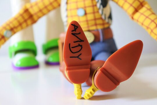 Name 'Andy' written in black marker on the bottom of Woody's cowboy boot. Toy Story movie concept. 