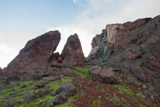 This are rocks of valley of statues. There are travellers between rocks. There are rocks on tht foreground.