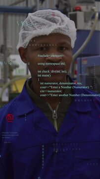 Vertical video: Factory worker monitoring control panel, camera centering as code overlay growing