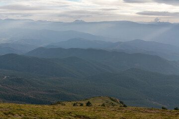 Fototapeta premium Atmospheric layered mountain ranges with soft light and haze near Jaca, Pyrenees, Spain. Natural scenic background.