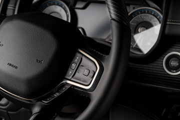 Obraz premium New car interior steering wheel, digital speedometer close up
